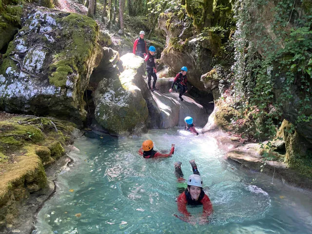 Small slide during the canyoning course of Chaley Canyon in Bugey region
